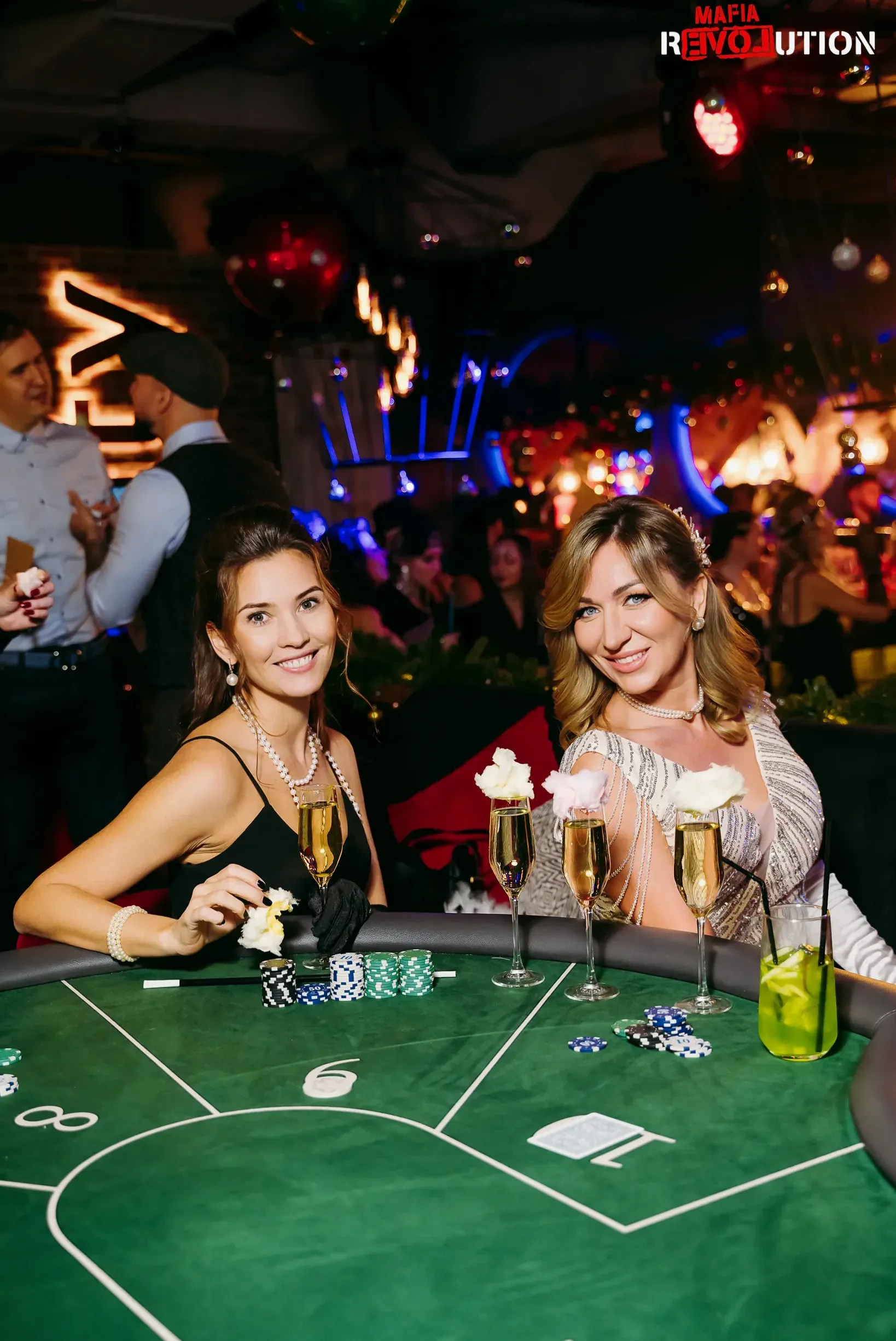 Guests playing cards over drinks at the dining lounge table