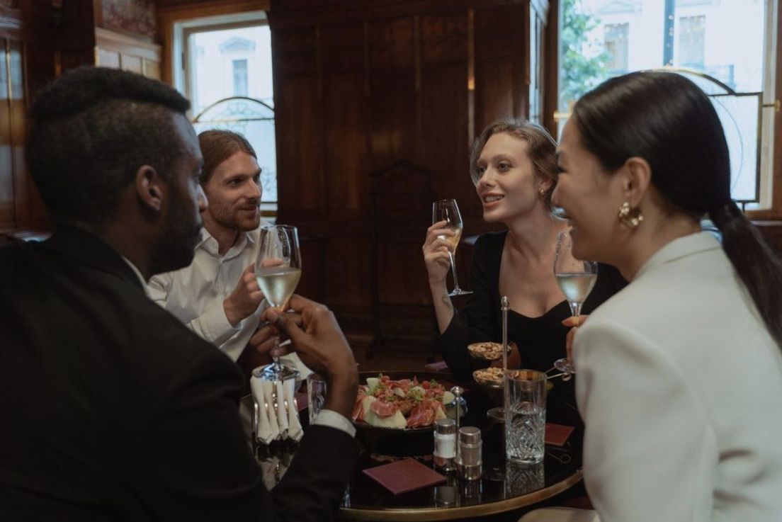 Friends sharing drinks and conversation during an evening gathering